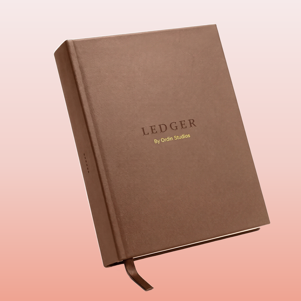 The Ledger by Ordin Studios - brown hardcover 12-month monthly dashboard journal, front cover with debossed LEDGER wordmark and ribbon marker
