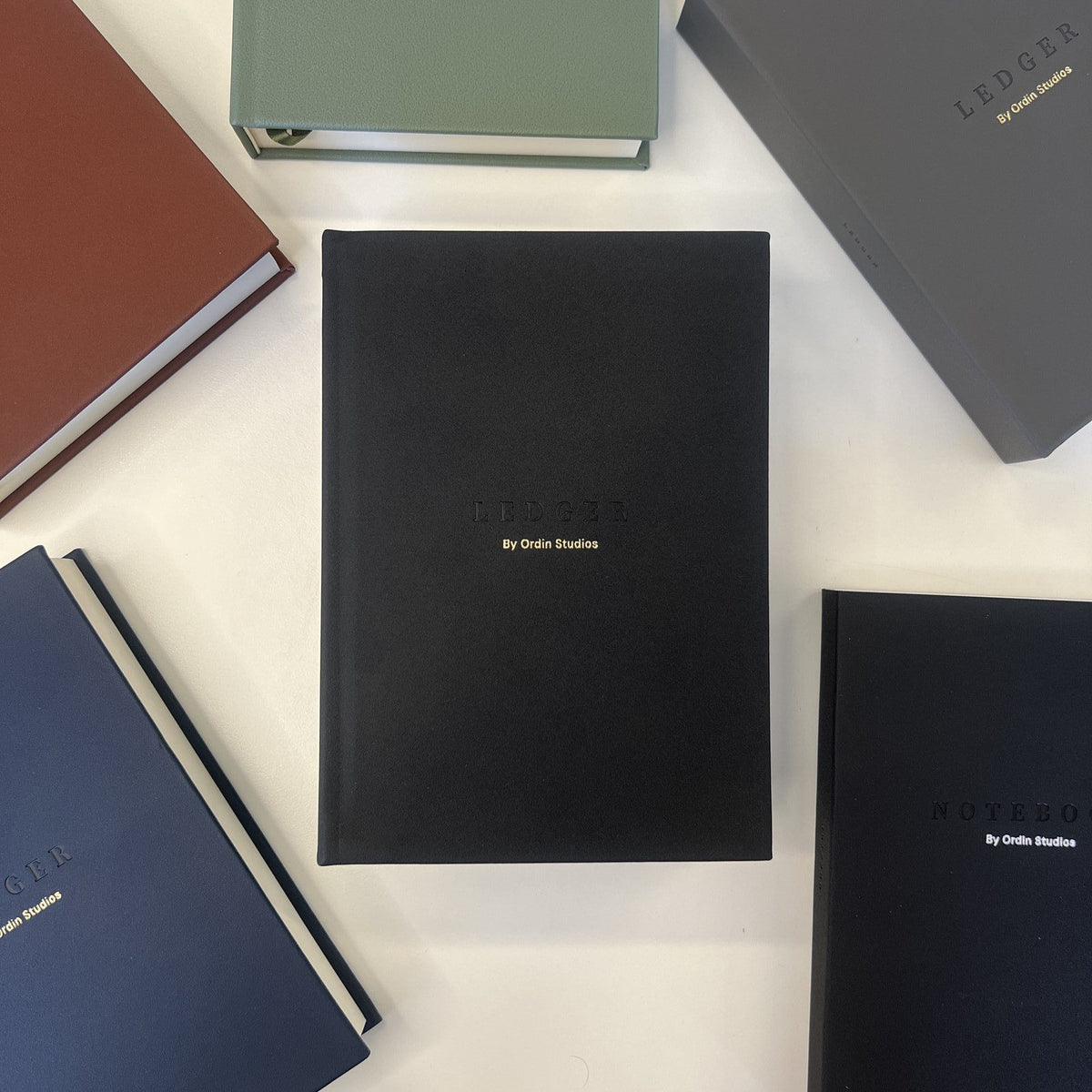 The Ledger in Black, flat-lay among the collection