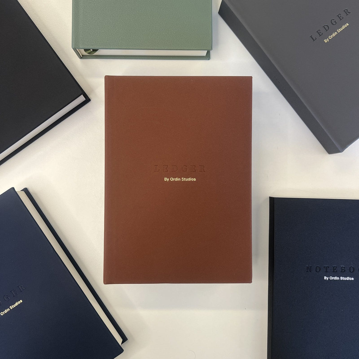 The Ledger in Brown, flat-lay among the collection