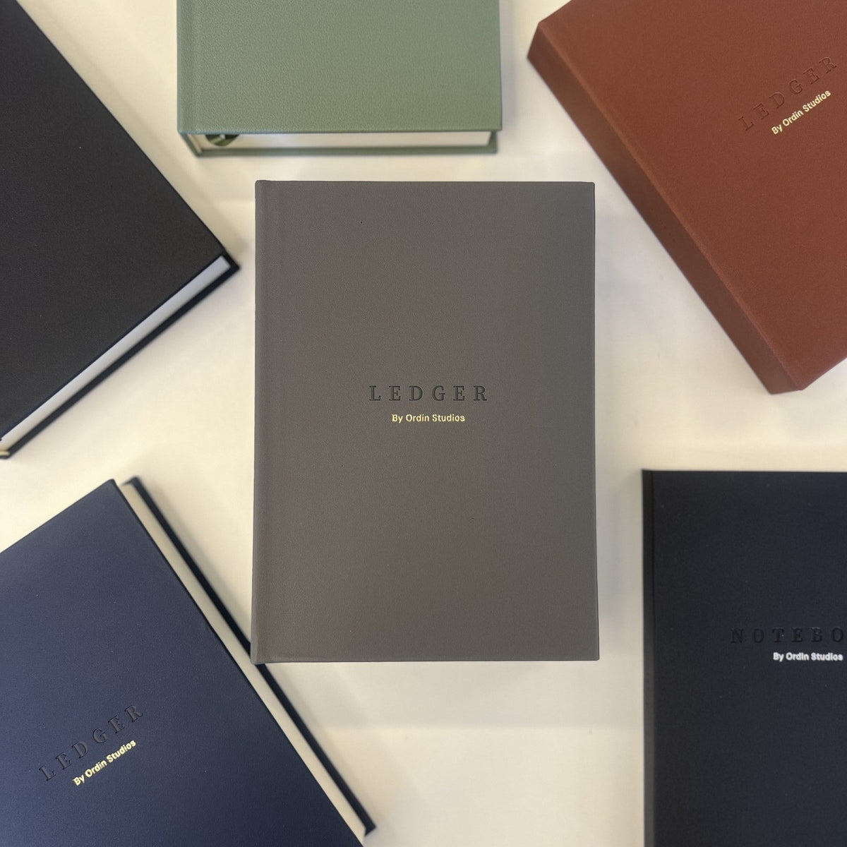 The Ledger in Charcoal, flat-lay among the collection