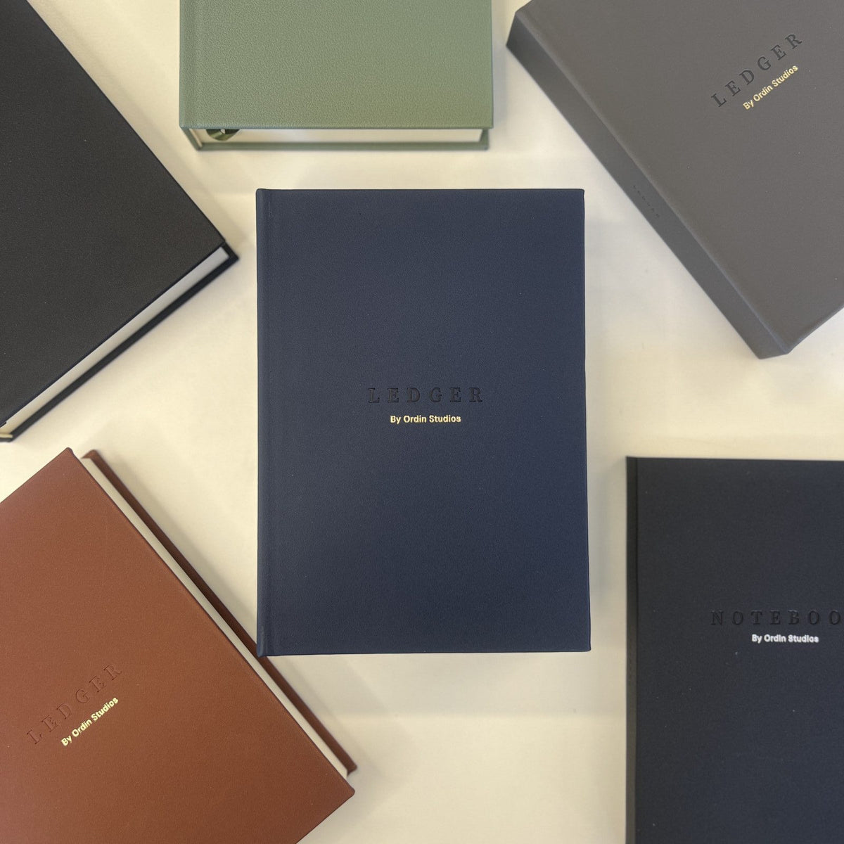 The Ledger in Navy, flat-lay among the collection